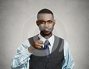 Confident businessman, pointing finger at you