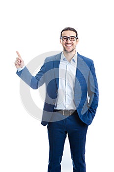 Confident businessman pointing up forefinger smiling isolated on white background. Contented business person, wearing eyeglasses,