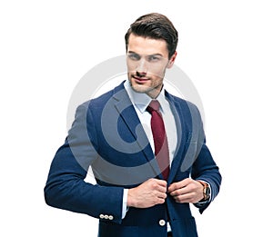 Confident businessman putting on suit jacket