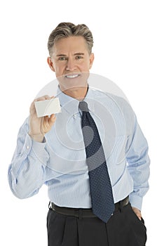 Confident Businessman Showing Blank Business Card