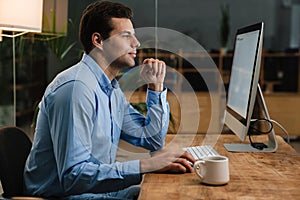 Confident businessman sitting at office desk