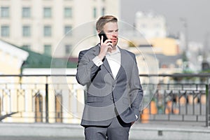 Confident businessman speaking on phone. making business on move. business man with mobile phone. wireless connection