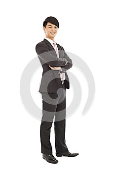 Confident businessman standing and across arms