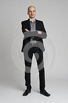 Confident businessman standing arms crossed