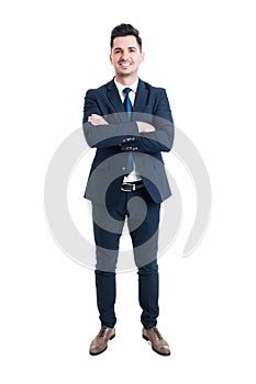 Confident businessman standing with arms crossed and smiling