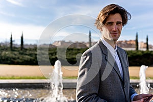 Confident businessman standing near fountain