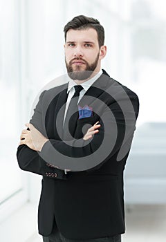 Confident businessman standing near the office window