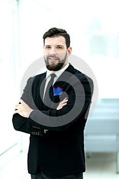 Confident businessman standing near the office window