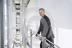 Confident Businessman Standing By Railing
