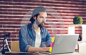 Confident businessman using laptop