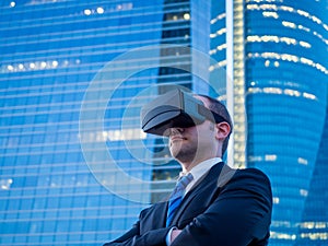 Confident businessman using virtual reality glasses in a business center