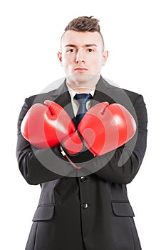 Confident businessman wearing boxing gloves and arms crossed