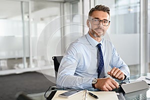 Confident businessman working on digital tablet