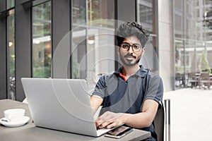 Confident businessman working on laptop at his workplace at modern office, Young handsome student men using laptop computer