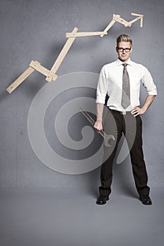 Confident businessman with wrench and graph.