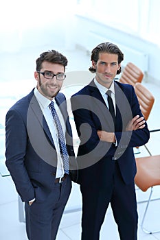 Confident businessmen standing together in office