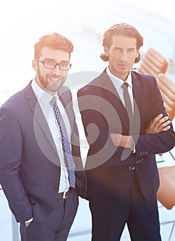 Confident businessmen standing together in office