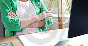 Confident businesswoman CEO sitting with crossed arms in office