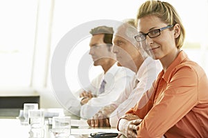 Confident Businesswoman With Colleagues In Conference Room