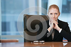 Confident Businesswoman At Conference Table photo