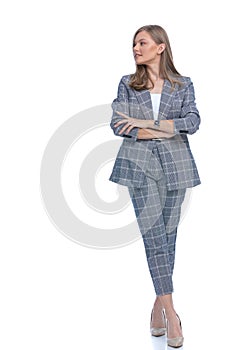 Confident businesswoman crossing arms and looking to side