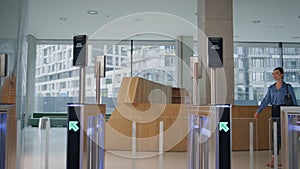 Confident businesswoman entering office turnstile. Lady looking screen face id