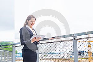 Confident businesswoman in front of modern office building. Business, banking, corporation and financial market concept.