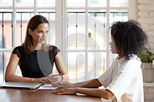 Confident businesswoman hr manager holding interview with African American woman