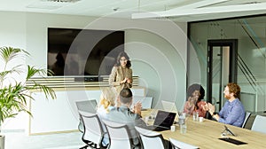 Confident businesswoman leading a strategic planning session in a modern office