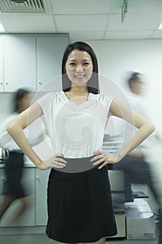 Confident Businesswoman with Rushing Colleagues Behind Her