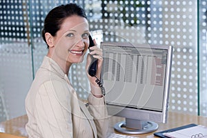 Confident businesswoman speaking on phone