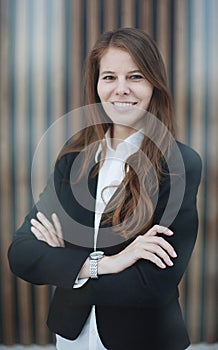 Confident businesswoman standing with her arms crossed. smiling and looking at the camera.