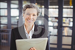 Confident businesswoman using digital tablet