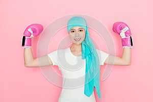 Confident cancer patient wearing boxing gloves
