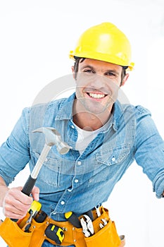 Confident carpenter using hammer