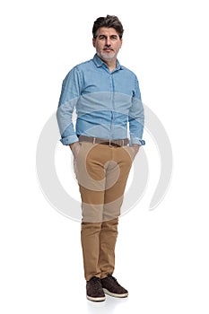 Confident casual man holding both hands in his pockets
