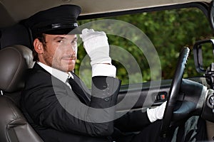 Confident chauffeur in elegant automobile