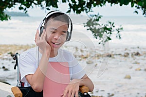 Confident child on wheelchair remote with computer