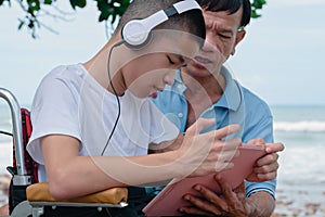 Confident child on wheelchair remote with computer with parent