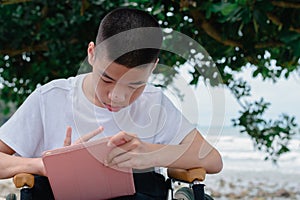 Confident child on wheelchair using social media photo