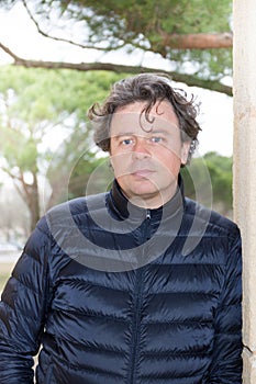 Confident Close up portrait of healthy man standing outdoors in park