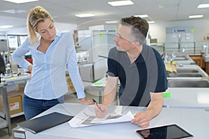 Confident co-workers discussing plans in office