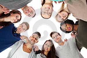 Confident college students forming huddle photo