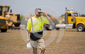 Confident contractor inspecting progress of new construction project. contractor review construction site. Construction