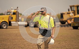 Confident contractor inspecting progress of new construction project. contractor review construction site. Construction
