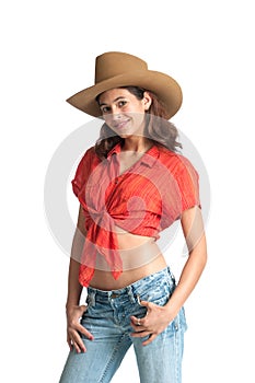 Confident cowgirl standing with thumbs hooked in jeans