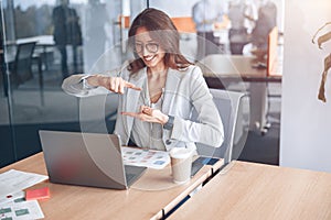 Confident deaf businesswoman communicating in video call at her workplace at modern office