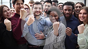 Confident diverse college students show fist up.
