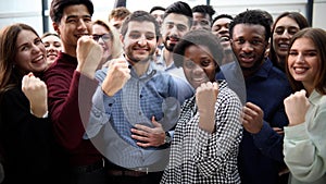 Confident diverse college students show fist up.