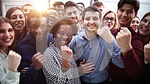 Confident diverse college students show fist up.